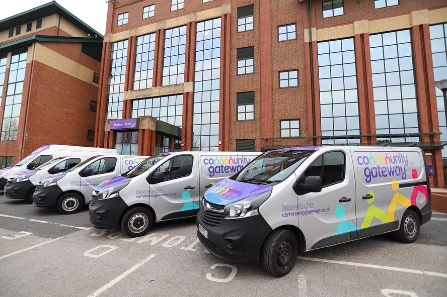 Showing Community Gateway vans outside CGA's offices at Harbour House on Preston Docks