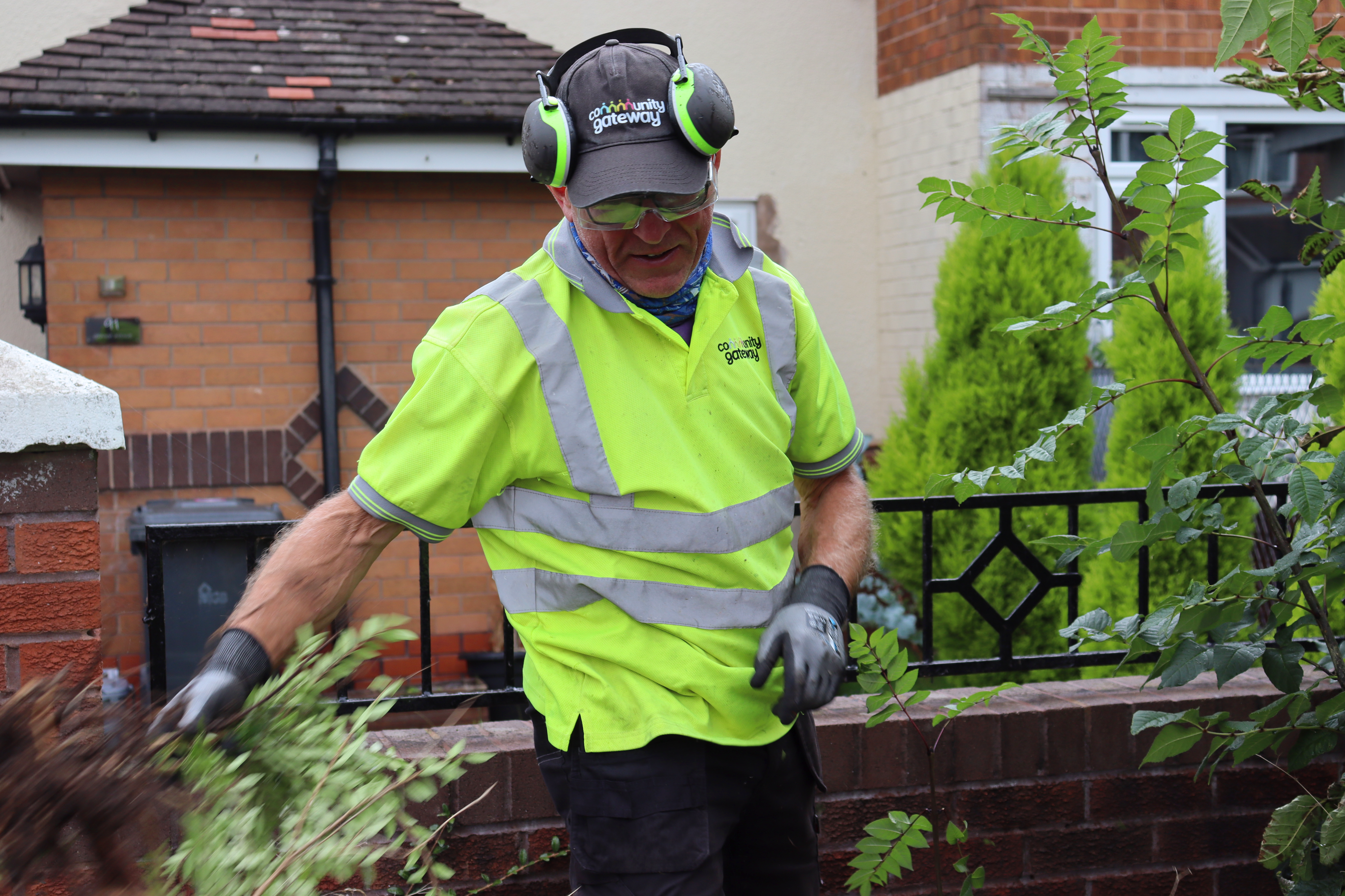 CGA staff member clearing overgrowth