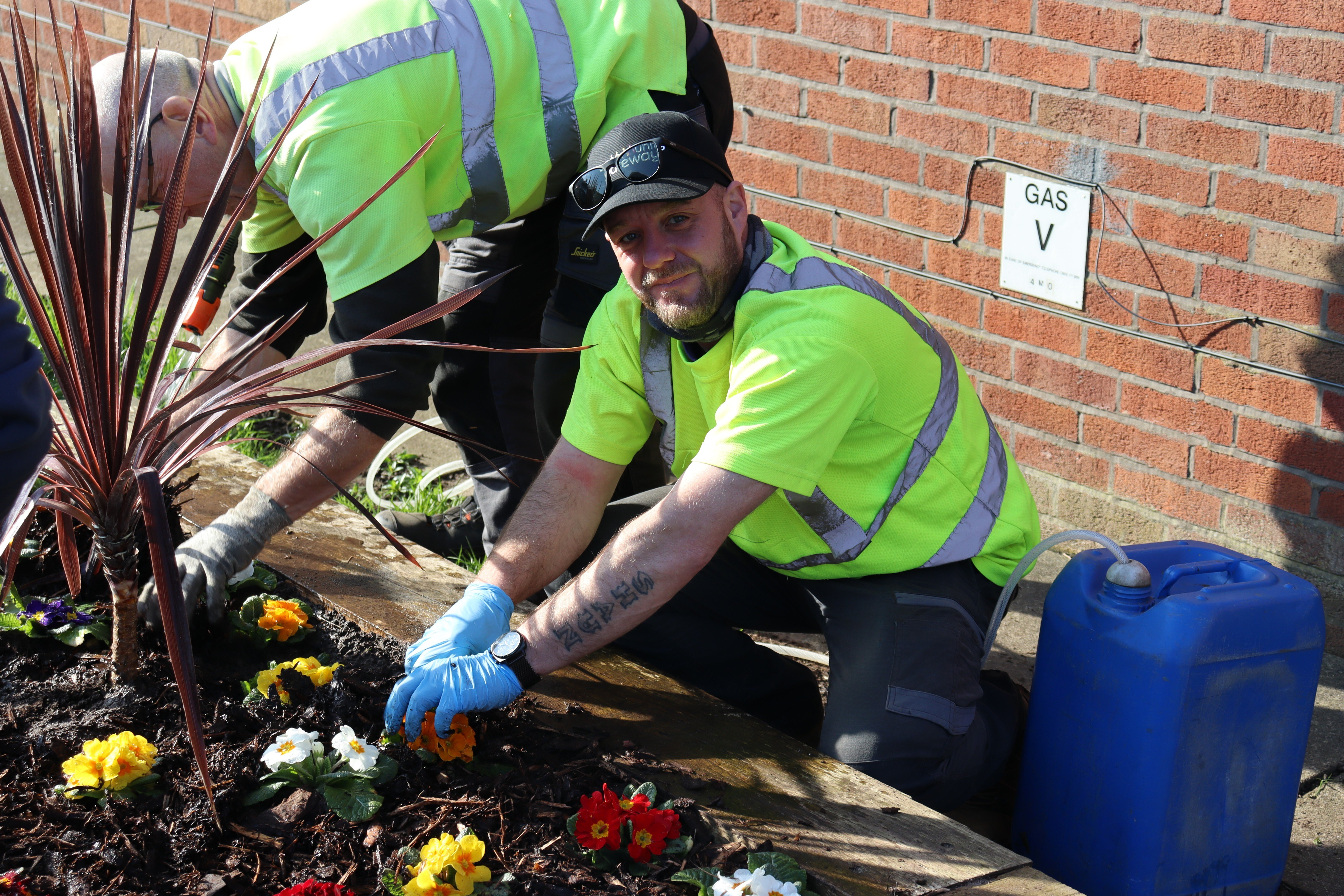 Our Greencare Team planting flowers in the planters