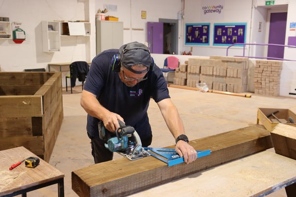 Man filing a plank of wood