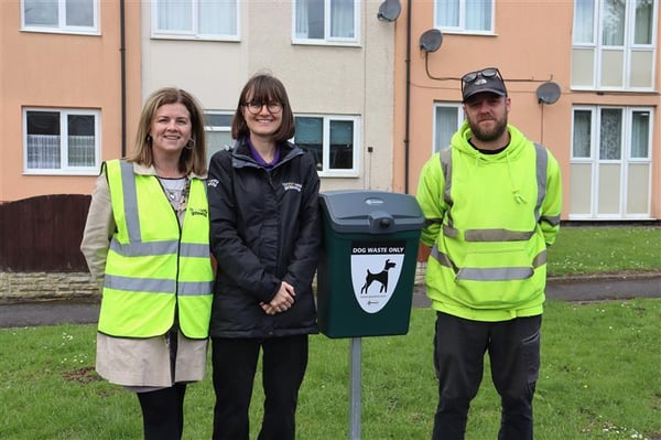 Image og colleagues next to a dog foul bin we have installed