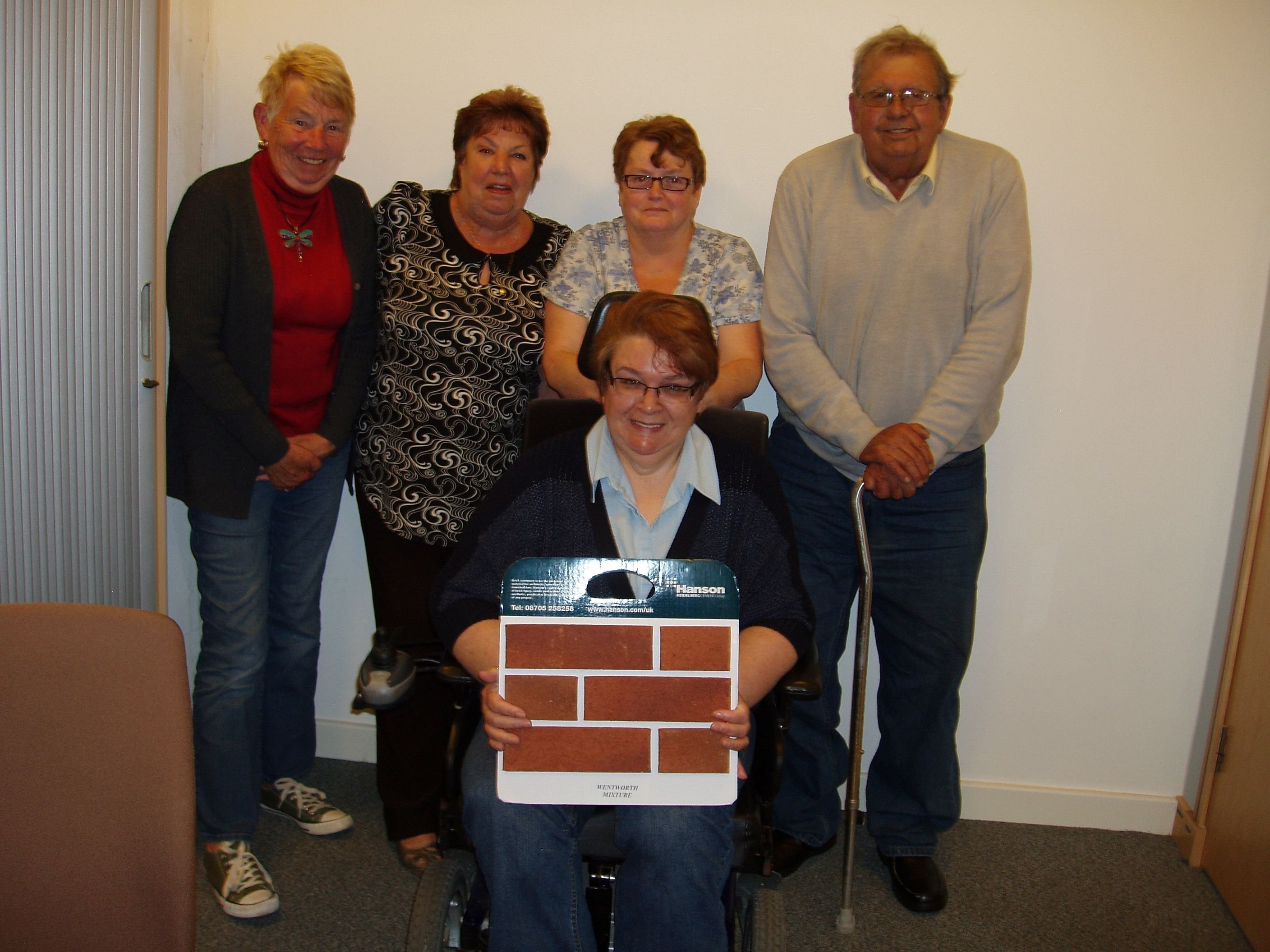 5 tenants with one holding a red brick pattern for our first tenant-led development 2015