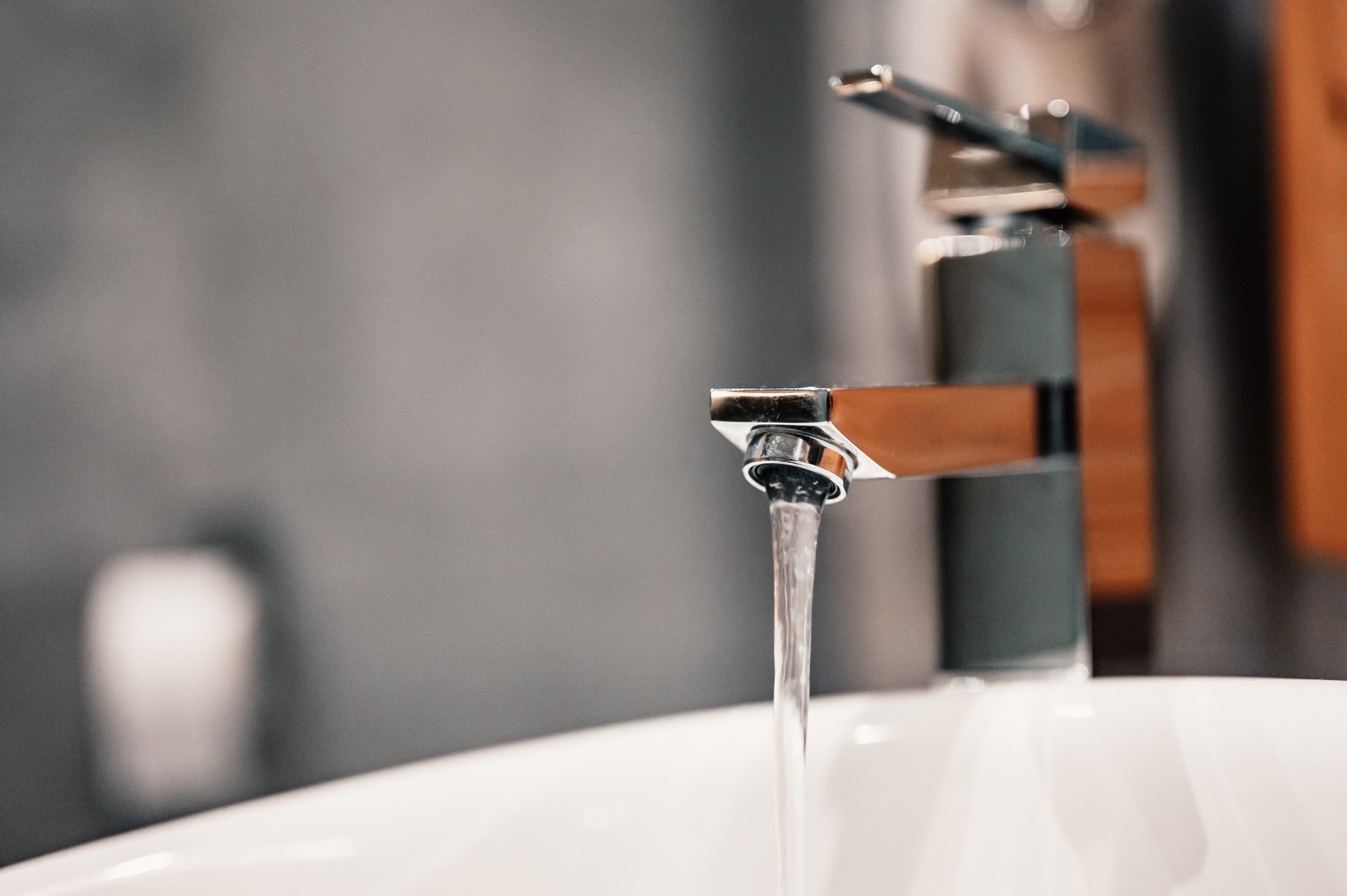 water-tap-faucet-flow-water-bathroom-with-sink-modern-clean-hause-hygiene-concept-panorama