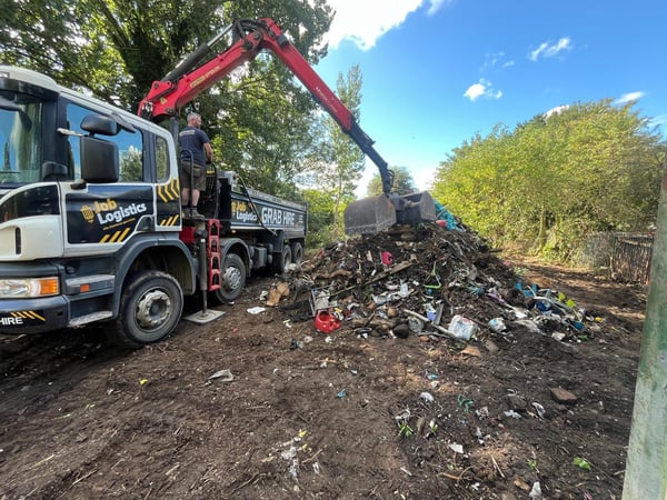 A large pile of fly tip being removed