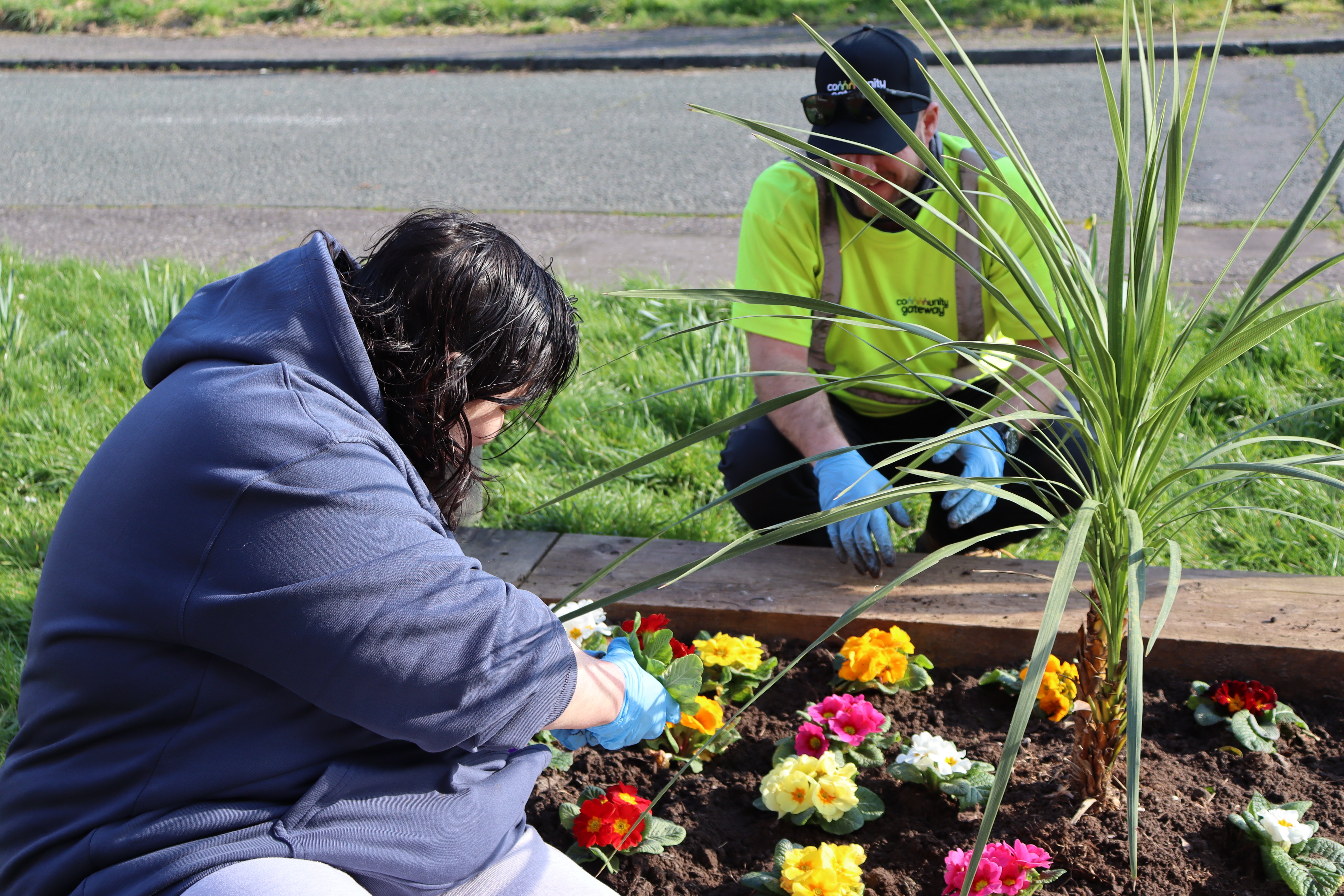 A tenant helping us plant flowers in the planters