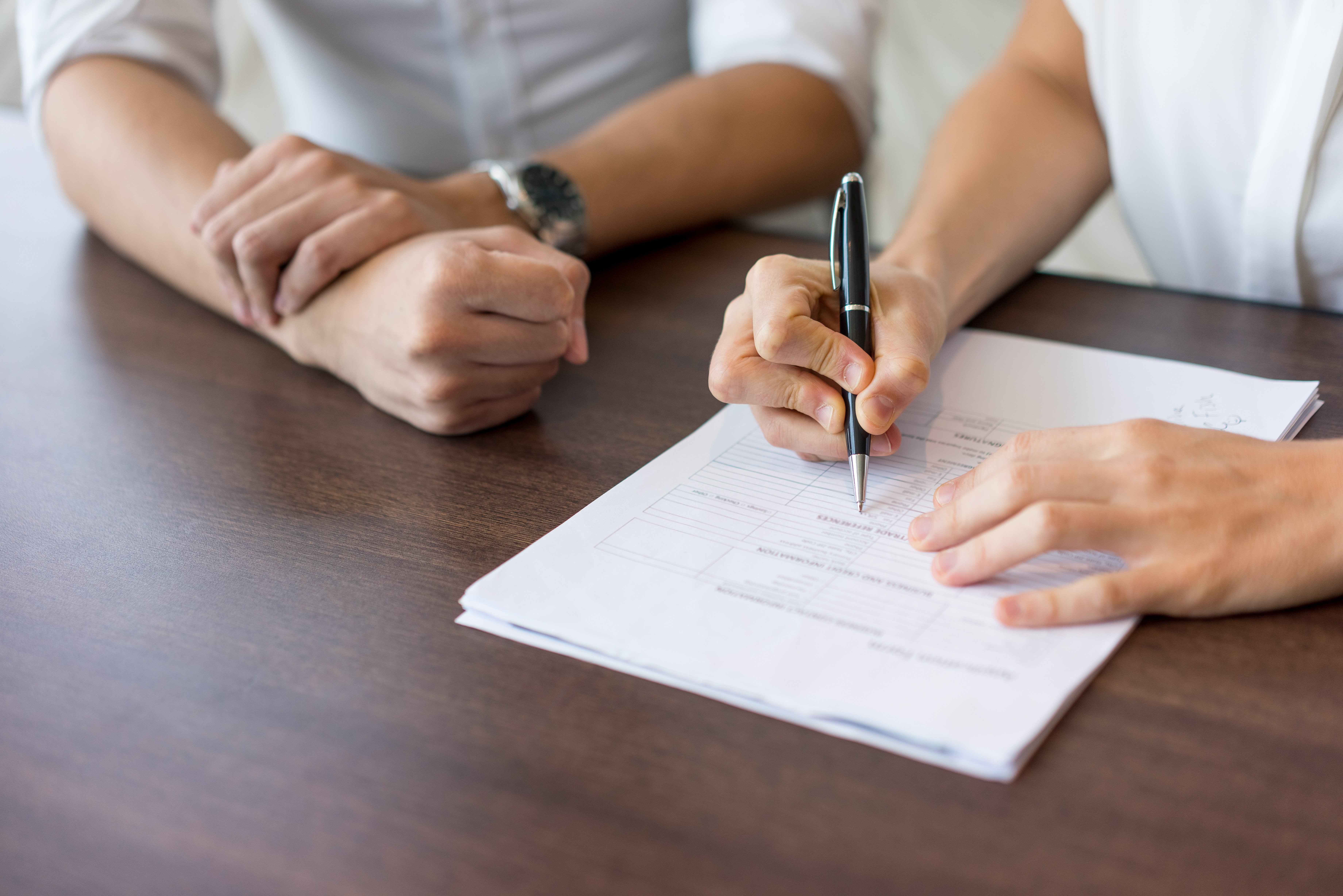 hand-female-hr-manager-filling-form-interview-with-male-candidate
