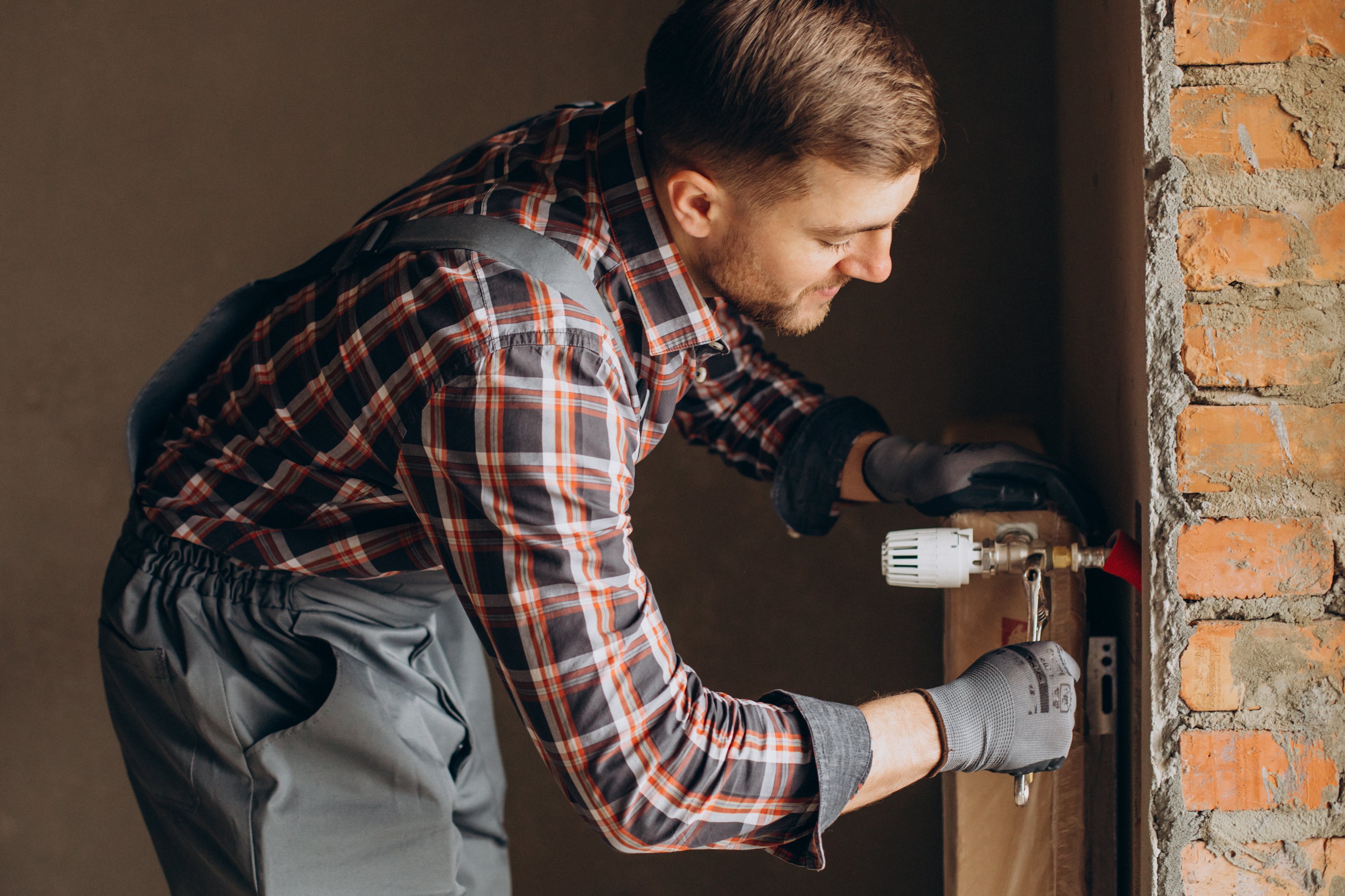 service-man-adjusting-house-heating-system
