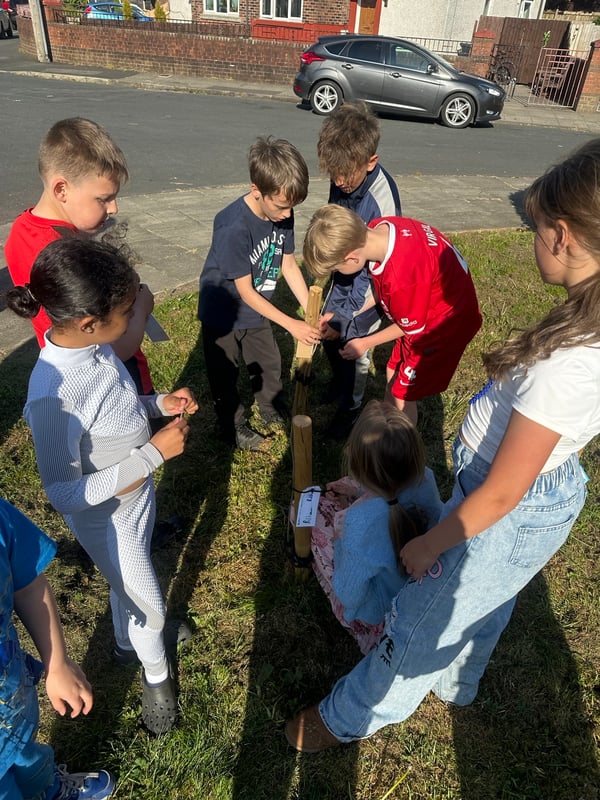 Children looking at where to plant the trees