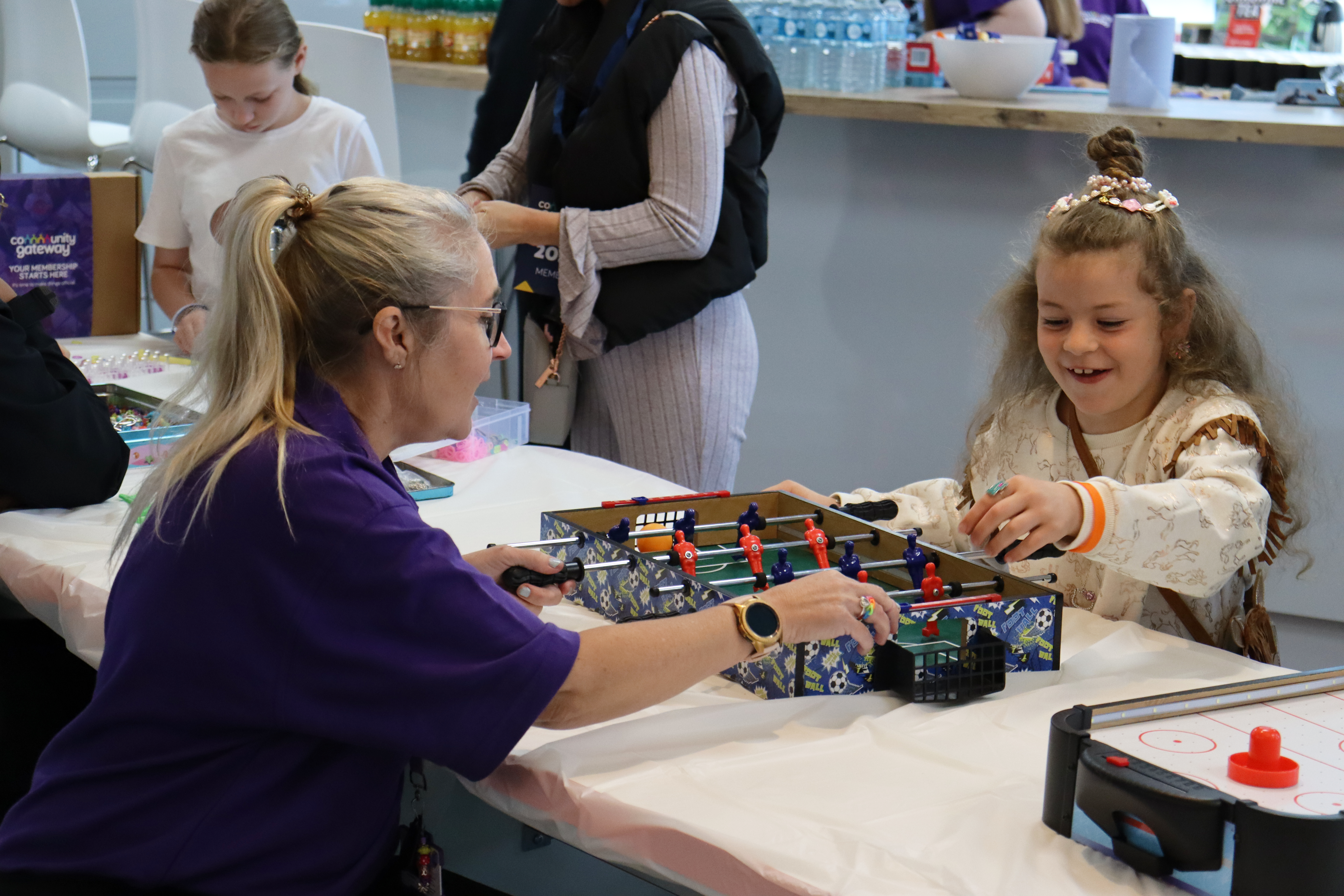 A young girl play table football 