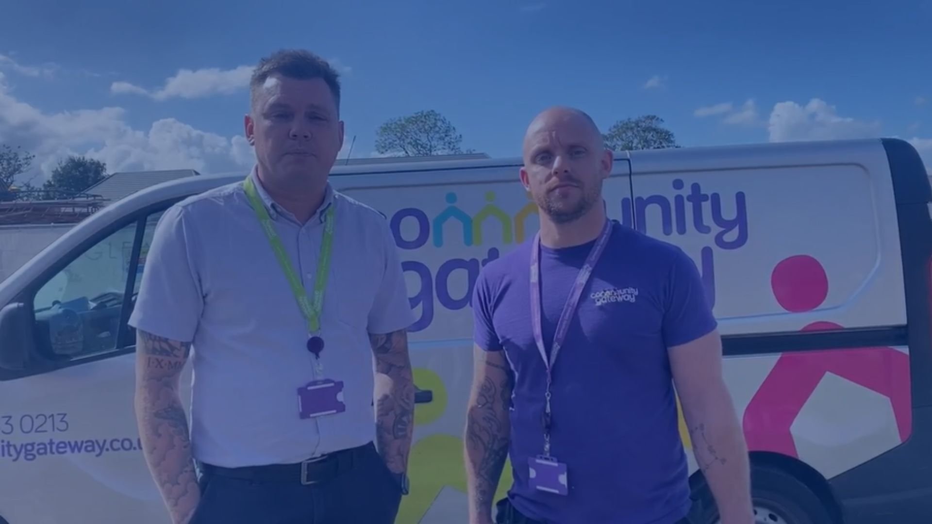 Two male CGA staff members stood in front of a branded van, looking at the camera