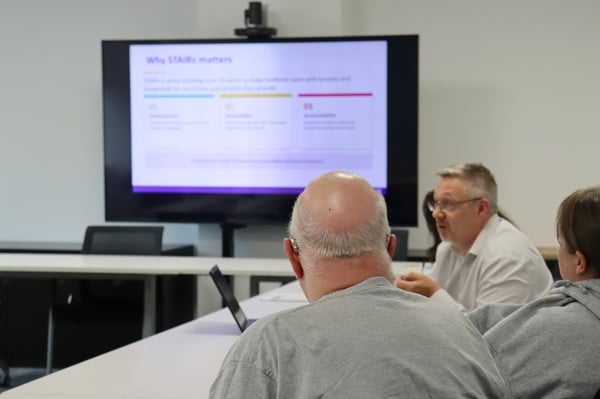 Tenants discussing and looking at a presentation