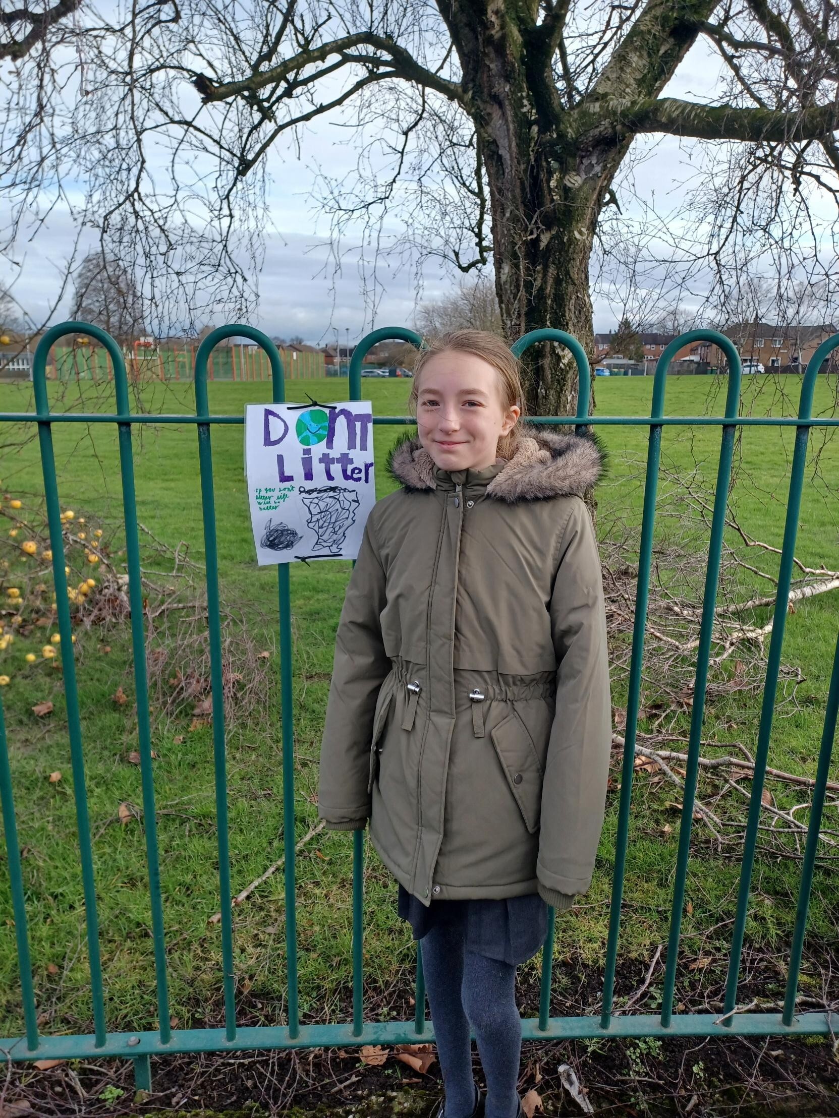 A student infront of the poster they designed