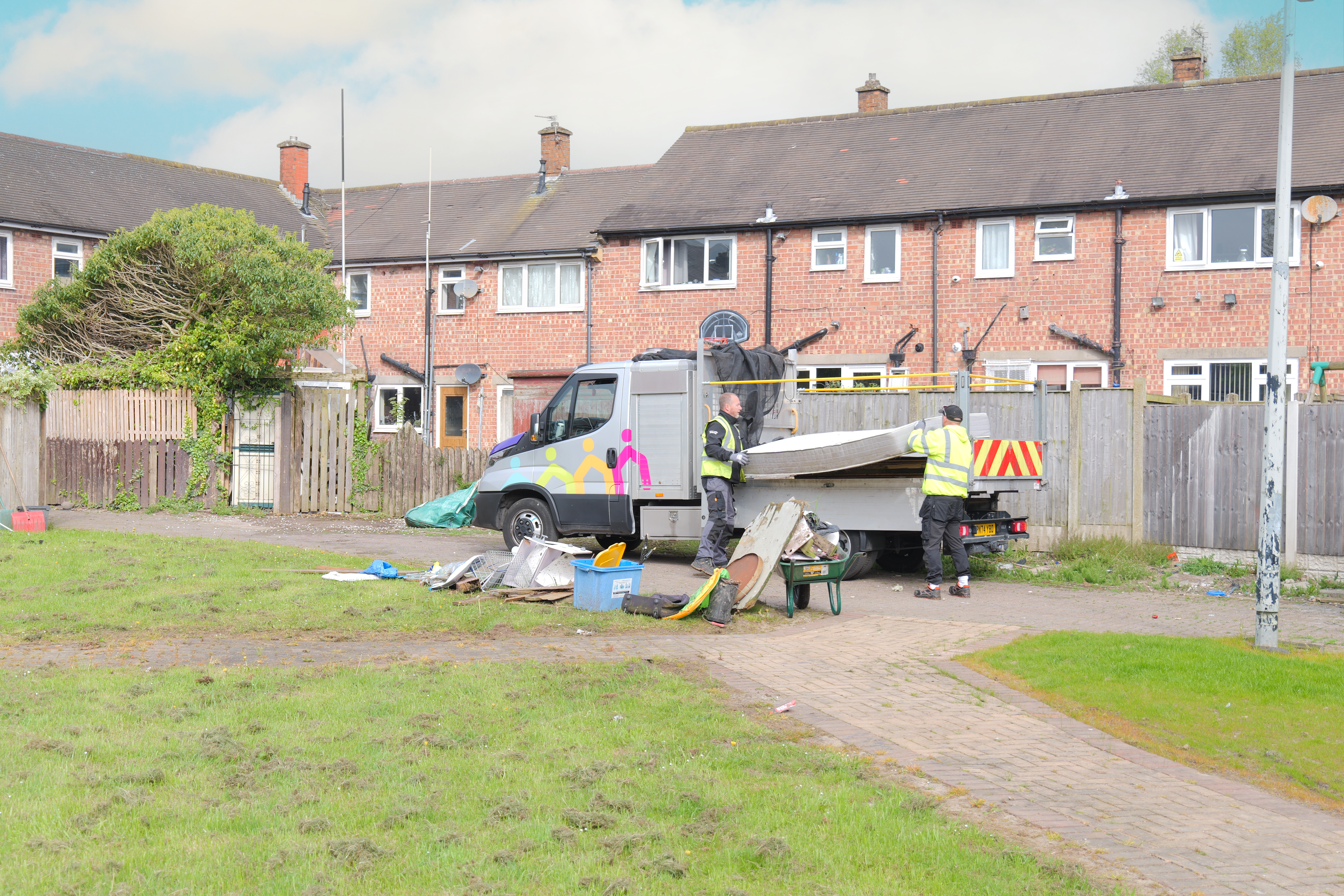 CGA van being loaded with fly-tip removed from communal areas