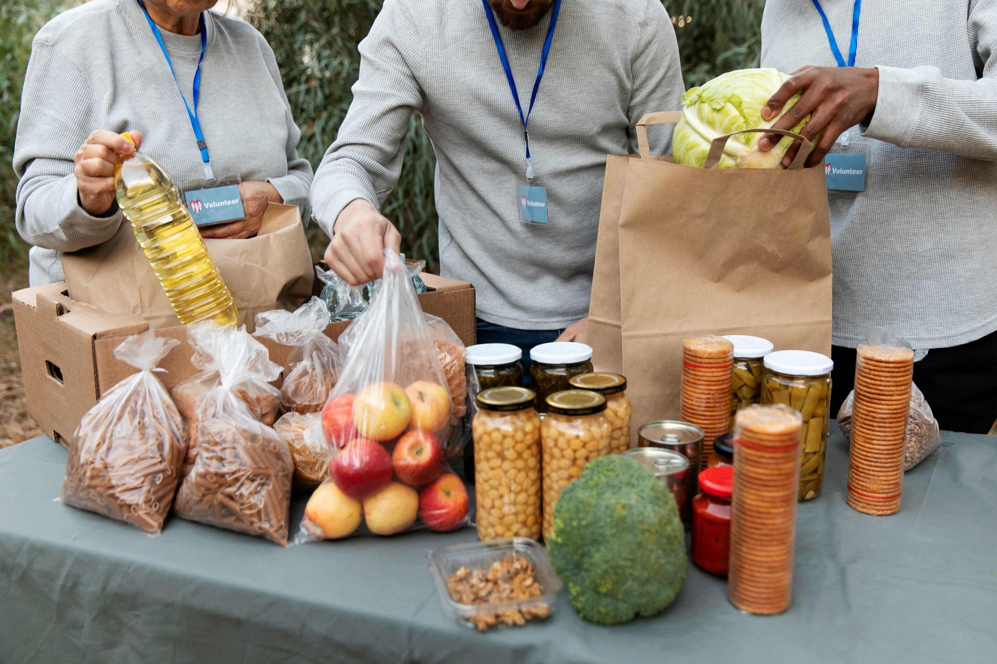 Showing a group of volunteers making up bags of food at a food bank